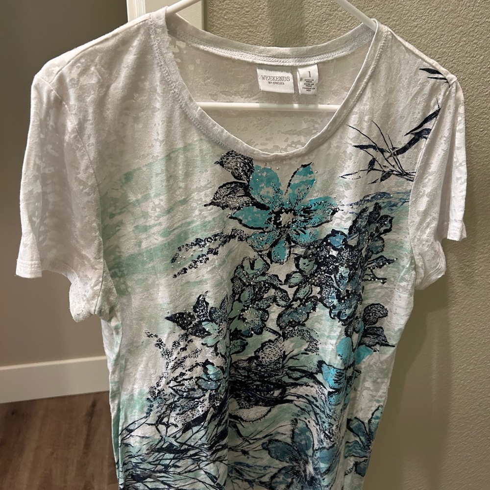 Chicos size 1 blouses in various colors.